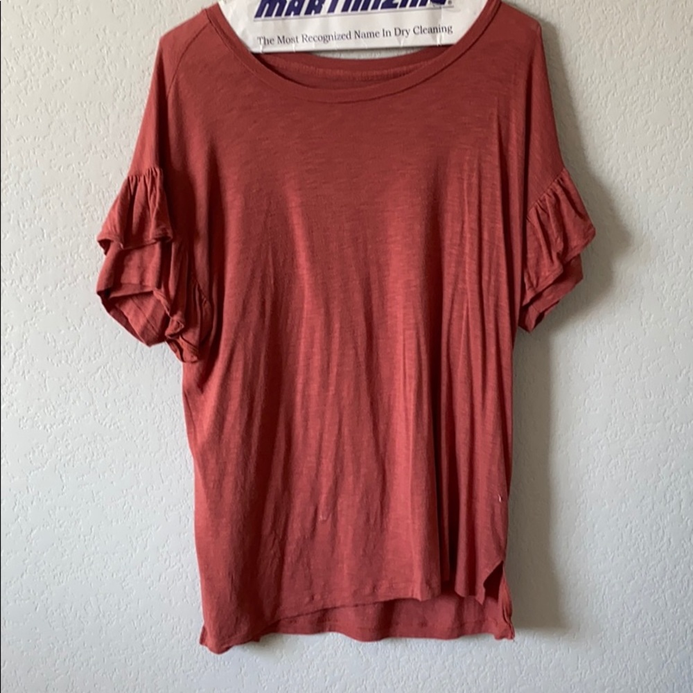 An orange top that is from American Eagle.